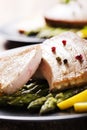 Grilled tuna steak served on asparagus with roasted potatoes Royalty Free Stock Photo