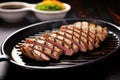 grilled tuna steaks with a bowl of soy sauce