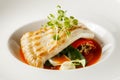 Grilled turbot, tabouli, sweet pepper sauce and summer vegetables. White dish Royalty Free Stock Photo