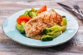 Grilled turkey fillet with vegetables on blue plate Royalty Free Stock Photo