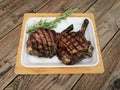 Grilled veal chop on wood table