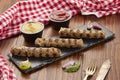 Grilled Veal minced meat with spices on black stone and wooden background