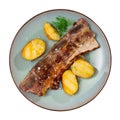 Grilled veal ribs churrasco with baked potatoes and greens Royalty Free Stock Photo