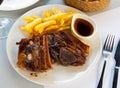 Grilled veal ribs with french fries and herbal sauce Royalty Free Stock Photo