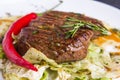 Grilled veal steak with vegetables on a plate Royalty Free Stock Photo