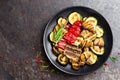 Grilled vegetable salad. Salad of barbecued zucchini, eggplant, sweet pepper, onion and mushrooms Royalty Free Stock Photo