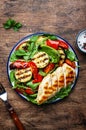 Grilled vegetables and chicken fillet salad with spinach. Paprika, zucchini, eggplant, tomatoes on rustic wooden table background Royalty Free Stock Photo