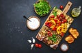 Grilled vegetables: colorful paprika, zucchini, eggplant, mushrooms, tomatoes and onions served on rustic wooden cutting board, Royalty Free Stock Photo