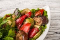 Grilled vegetables with parsley on a plate. Eggplants, zucchini, grilled peppers Royalty Free Stock Photo