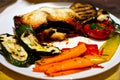 Grilled vegetables on a plate, eggplant, carrots, zucchini and cheese