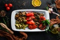 Grilled vegetables on a plate. Tomatoes, eggplants, mushrooms, zucchini. Dishes, food. Top view. Royalty Free Stock Photo