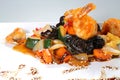 Grilled vegetables with shrimp and wood mushrooms in teriyaki sauce on a white plate Royalty Free Stock Photo