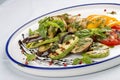 Grilled vegetables - tomatoes, zucchini, eggplant, sweet pepper, mushrooms. In a white plate Royalty Free Stock Photo