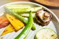 Grilled vegetables in white plate. Pepper, mushroom, zuchini and asparagus close up. Selective focus Royalty Free Stock Photo
