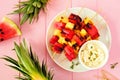 Grilled summer watermelon and pineapple fruit kabobs with feta, above view over pink wood Royalty Free Stock Photo