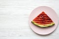 Grilled watermelon on a pink plate over white wooden background, from above. Healthy summer fruit. Royalty Free Stock Photo