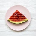 Grilled watermelon on a pink plate over white wooden background, overhead view. Healthy summer fruit. Flat lay, top view Royalty Free Stock Photo