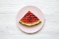 Grilled watermelon on a pink plate over white wooden surface, from above. Healthy summer fruit. Flat lay Royalty Free Stock Photo