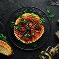 Grilled watermelon with raspberries and parsley on a black plate. Top view. Royalty Free Stock Photo