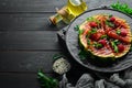 Grilled watermelon with raspberries and parsley on a black plate. Top view. Royalty Free Stock Photo