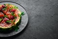 Grilled watermelon with raspberries and parsley on a black plate. Top view. Royalty Free Stock Photo