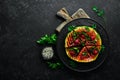 Grilled watermelon with raspberries and parsley on a black plate. Top view. Royalty Free Stock Photo