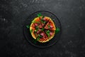 Grilled watermelon with raspberries and parsley on a black plate. Top view. Royalty Free Stock Photo