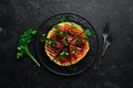 Grilled watermelon with raspberries and parsley on a black plate. Top view. Royalty Free Stock Photo