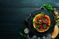 Grilled watermelon with raspberries and parsley on a black plate. Top view. Royalty Free Stock Photo