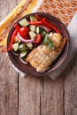Grilled white fish with vegetables. vertical top view