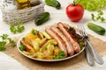 Grilled white sausages with roasted potatoes.