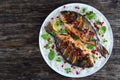 Grilled whole fish on bed of rice