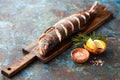 Grilled whole humpback salmon fish with lemon on a wooden cutting board