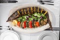 Grilled Whole sturgeon Fish with lemon and grilled vegetables on plate Royalty Free Stock Photo