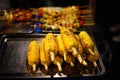 Grilled yellow corn arrangement prepare on stainless tray.