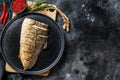 Grilled Yellowtail, Japanese amberjack fillet on a plate. Black background. Top view. Copy space