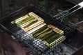 Grilled zucchini. Cooking an appetizing dish grill grate with slices of zucchini over coals on grill. Seasonal summer dish.