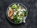 Grilled zucchini, mozzarella, cilantro salad with olive oil, lemon, garlic, pepper sauce on a dark background, top view Royalty Free Stock Photo