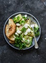 Grilled zucchini, mozzarella, cilantro salad with olive oil, lemon, garlic, pepper sauce on a dark background, top view Royalty Free Stock Photo