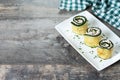 Grilled zucchini rolls stuffed with cream cheese and tuna on wooden table Royalty Free Stock Photo