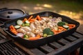 a griller with chicken and veggies, ready to cook