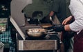 grilling barbecue steak. man holding steel spoon and roasting me