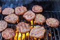 Grilling beef meat barbecue burgers on the barbecue grill using a fire flame Royalty Free Stock Photo