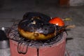 Grilling of Brinjal and tomato on coal stove or charcoal stove or mitti ka chulha or charcoal chulha or coal chulha or charcoal