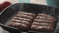 Grilling Cevapcici Sausages in Pan with Steam.