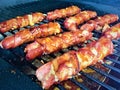 Grilling cheese-stuffed bacon-wrapped hotdogs