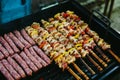 Grilling chicken meat skewers and kebab with vegetables on barbecue charcoal grill Royalty Free Stock Photo