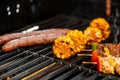 Grilling chicken skewers and corn on a barbecue Royalty Free Stock Photo