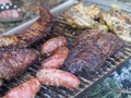 slow grilling chorizo sausages , chicken quarters, skirt and flank muscle steaks argentinian cuts Royalty Free Stock Photo