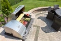 Grilling food on an outdoor gas barbecue Royalty Free Stock Photo